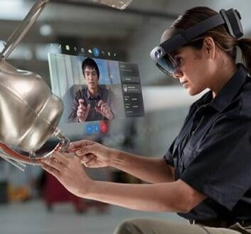 an engineer wearing halo lens and working on a rotor being helped by another engineer remotely