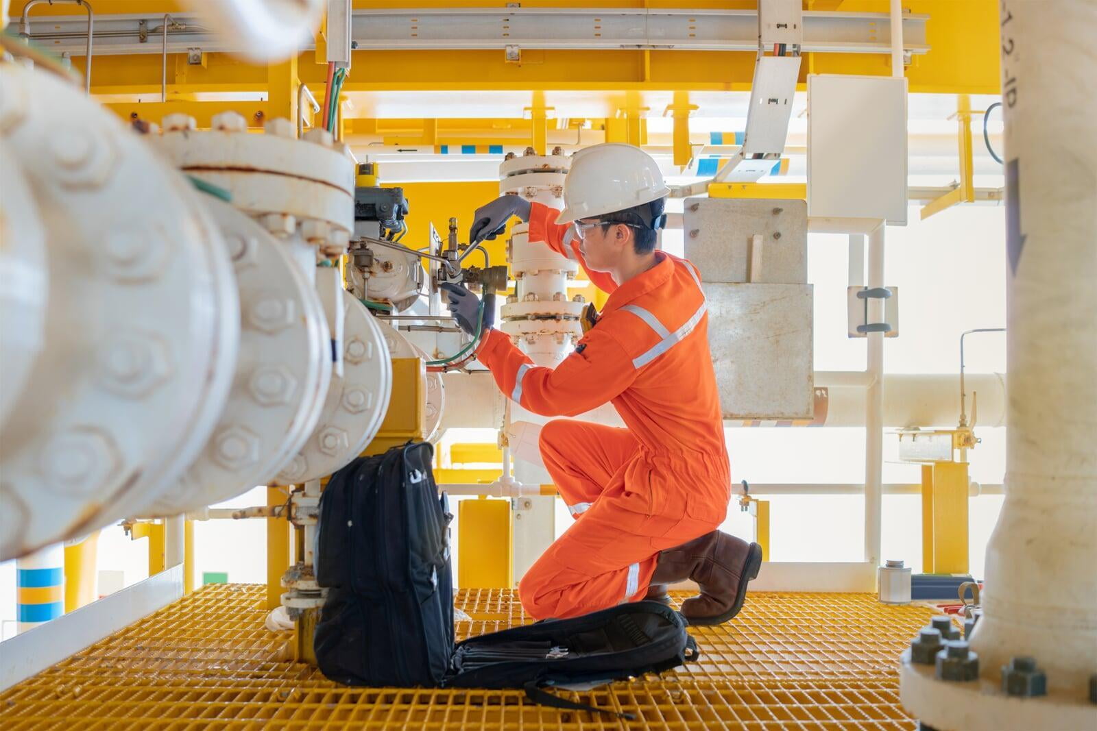 field services technician attempting to fix a machinery