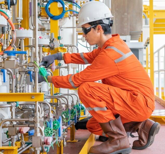 a field service technician repairing machinery