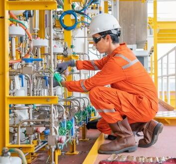 field service technician attempting a repair of machinery